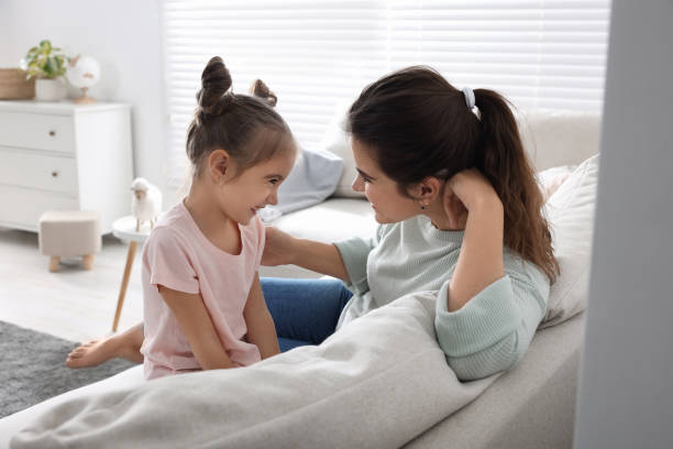 istock Young mother and her daughter spending time together on sofa at home 1812144633