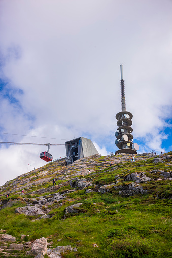 Bergen, Norway - June 23, 2023: The TV tower, restaurant and cable car station located at the summit of Mt. Ulriken, the highest of the Seven Mountains at Bergen, Norway, is a welcome site for hikers.