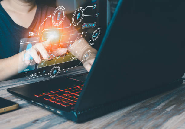 istock A male entrepreneur, using a laptop, connects to the internet and showcases graphics that extend beyond the screen, creating a hologram-like display that captivates his audience. 1812239318
