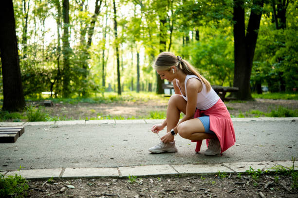 istock Young woman jogging at the park 1812239437