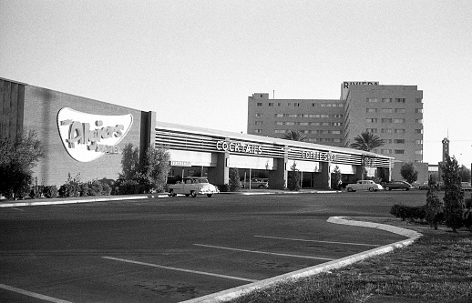 Entrance to Algiers Hotel, 2845 South Las Vegas Blvd., with the high rise Rivieria Hotel, 2901 South Las Vegas Blvd., in the background. The Riviera was the first high rise hotel at 9 stories in Las Vegas. Las Vegas, Nevada, USA 1959.