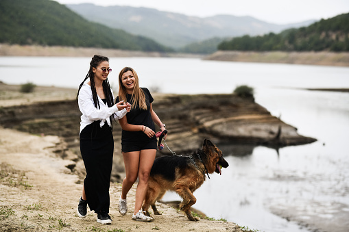 Lesbian Couple Having Interactive Conversation While Walking Their Cute Dog