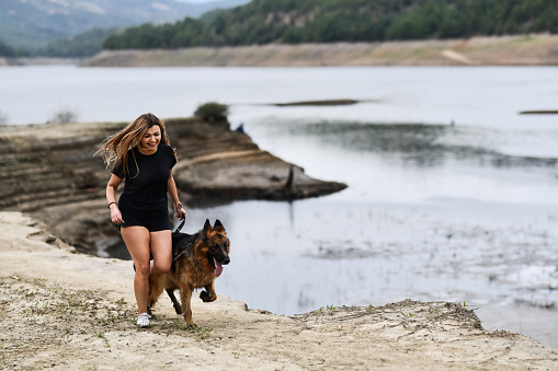 Jogging Session For Smiling Female And Her German Shepherd Dog