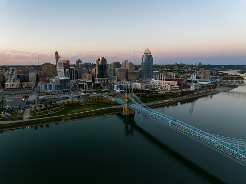 Aerial still image of the Central Business District behind the John A. Roebling Bridge at dusk in Cincinnati, Ohio. Authorization was obtained from the FAA for this operation in restricted airspace.