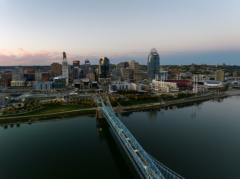 Aerial still image of the Central Business District behind the John A. Roebling Bridge at dusk in Cincinnati, Ohio. Authorization was obtained from the FAA for this operation in restricted airspace.