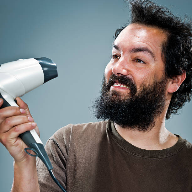 istock Young Happy Man with an Hair Dryer 181229777