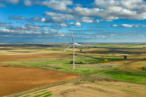 Wind turbine on a green field.
