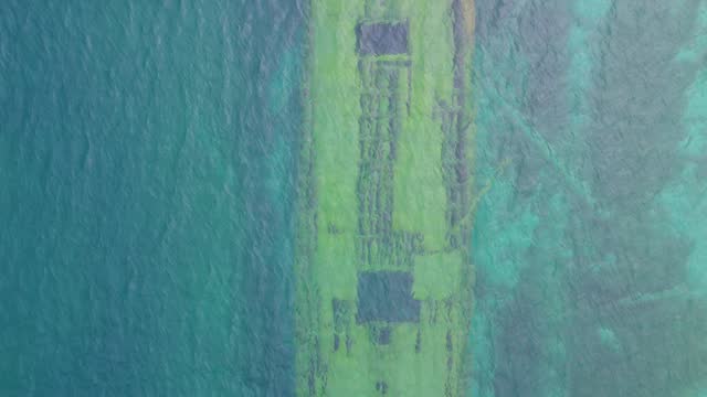 Boats moored near private homes in Bruce peninsula, aerial view. Shipwreck underwater