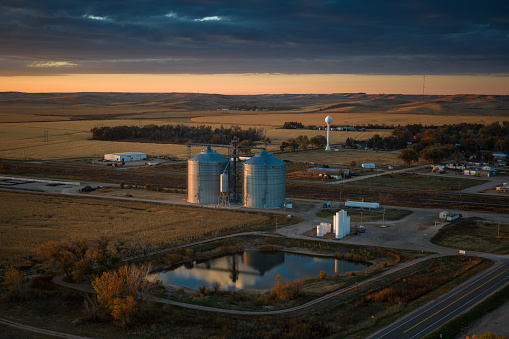 Aerial still image of a grain silos in the village of Brule, Nebraska, taken by a drone at sunset.