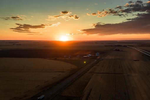 Aerial still image of acres of farmland in the village of Brule, Nebraska, taken by a drone at sunset.