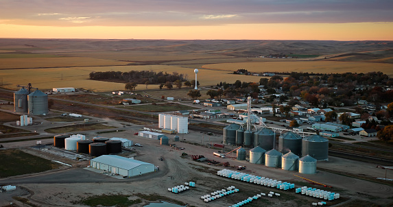 Aerial still image of grain silos in the village of Brule, Nebraska, taken by a drone at sunset.