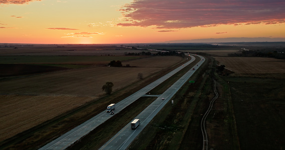 Aerial still image of Interstate 80 passing through the village of Brule, Nebraska, at sunset.