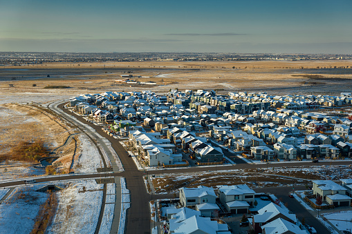 Aerial still image of snowcapped houses in the Beeler Park neighborhood in Denver, Colorado, taken by a drone on a snowy,  Fall day.