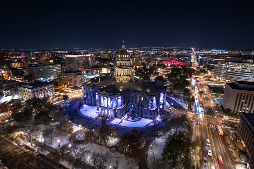 Aerial still image of the Colorado State Capitol building, taken by a drone on a snowy night in Denver.