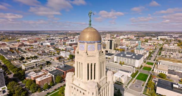 istock Nebraska State Capitol Tower under Cloudy Sky with Downtown Lincoln in Background 1812322010