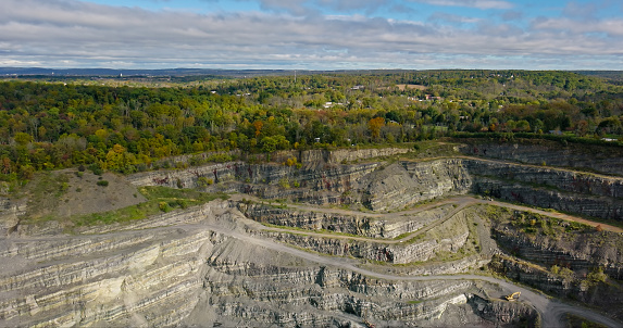 Aerial still image of a quarry in Perkiomenville, an unincorporated community located in Montgomery County, Pennsylvania, on a cloudy day in Fall.