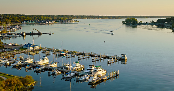 Aerial still of boat dock in White Lake, Whitehall, Michigan at sunset in Fall.
