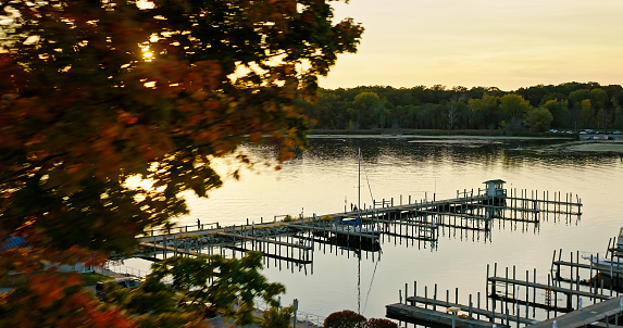 Aerial still of a pier in Whitehall, Michigan on a Fall sunset.