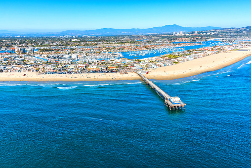 Aerial view of the beautiful Orange County California coastal town of Newport Beach from an altitude of about 1000 feet over the Pacific Ocean during a helicopter photo flight.