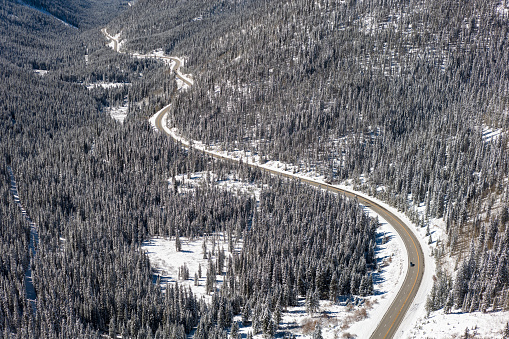 Aerial still image of a car passing on the winding Loveland Pass taken by a drone on a cold, Fall morning in Dillon, Colorado,