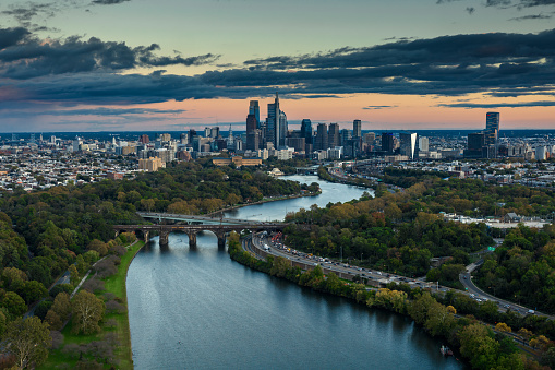 Aerial still image of the Center City skyline from over Schuylkill River in Philadelphia, Pennsylvania on a cloudy sunset in Fall.