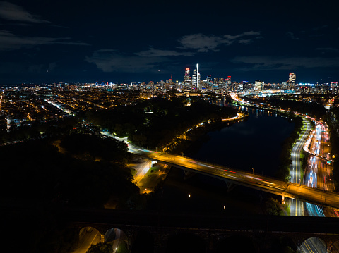 Aerial still image of the Center City skyline from over Schuylkill River in Philadelphia, Pennsylvania on a cloudy night in Fall.