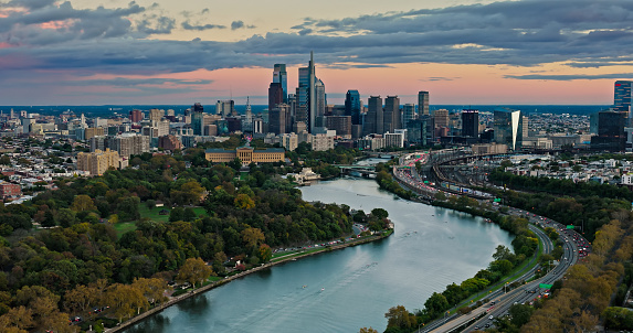 Aerial still image of the Center City skyline from over Schuylkill River in Philadelphia, Pennsylvania on a cloudy sunset in Fall.