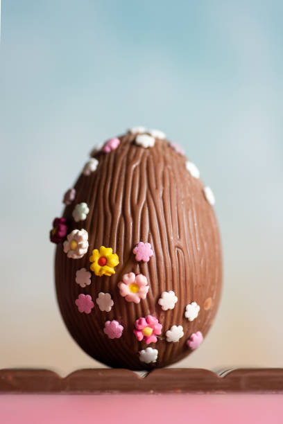 istock Easter chocolate egg decorated with small multicolored flowers 1812353125