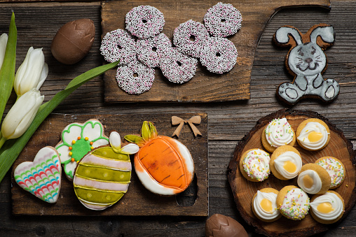 Sweets, pastries, gingerbread cookies on a wooden Easter table-Easter bunny, carrot, egg, flower, heart