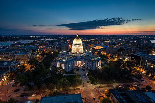 Aerial view of Wisconsin State Capitol building in downtown Madison, the capital city of Wisconsin, at twilight in Fall.\n\nAuthorization was obtained from the FAA for this operation in restricted airspace.