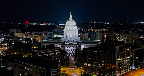 Aerial view of the Wisconsin State Capitol building in downtown Madison, the capital city of Wisconsin, at night in Fall.\n\nAuthorization was obtained from the FAA for this operation in restricted airspace.