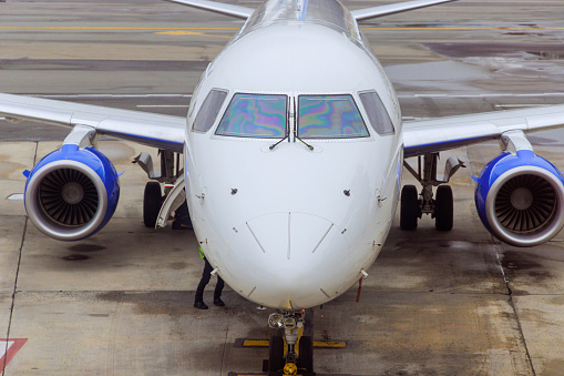 A passenger jet taxis towards an airport gate after landing.