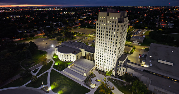 Aerial view of the North Dakota State Capitol building in Bismarck, the capital city of North Dakota, on an overcast sunset in Fall.\n\nAuthorization was obtained from the FAA for this operation in restricted airspace.