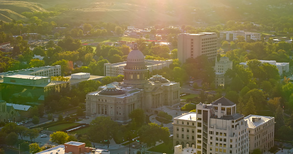 Drone shot of the Idaho State Capitol and commercial buildings in at sunrise on a Fall morning in Boise. \n\nAuthorization was obtained from the FAA for this operation in restricted airspace.
