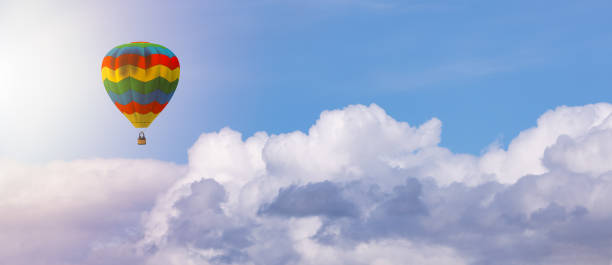 istock Hot Air Balloon flying over the White Puffy Clouds. 1812397785