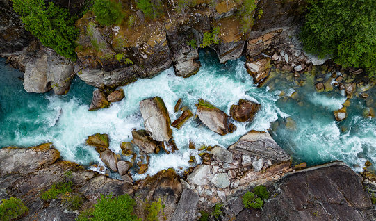 Cool water streaming down into a rocky pond.