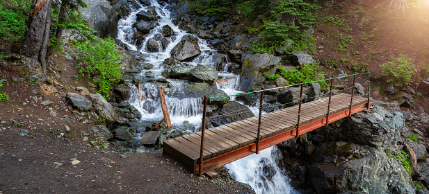 Hiking path and bridge across a river in the Canadian Nature mountains. Garibaldi, Whistler, British Columbia, Canada.