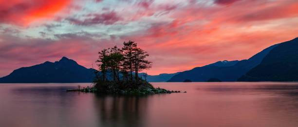 istock Dramatic Sunset on Ocean Coast with Canadian Mountain Landscape in Background. 1812412637