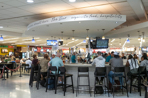 Atlanta, USA - April 23, 2023. Passengers dining at The Bar in the terminal of Atlanta Hartsfield-Jackson International Airport, Atlanta, Georgia, USA