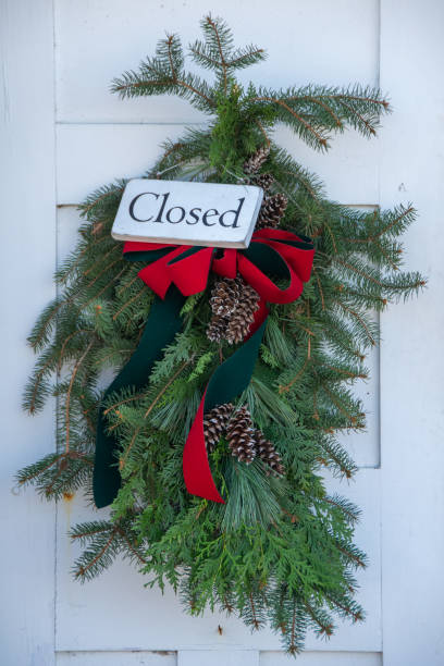 istock Evergreen Swag on a Door with a Closed Sign 1812471601