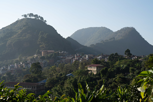 A beautiful view of the town of Bandipur, Nepal with some small hills in the background in the afternoon sunshine.