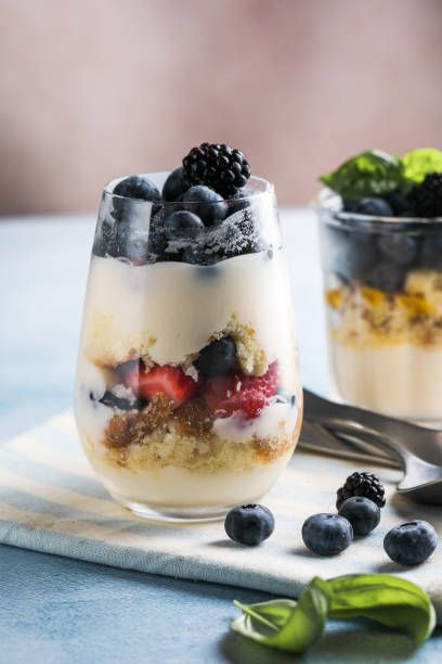 istock Trifle dessert with berries and cream on wooden table. Copy space 1812493140