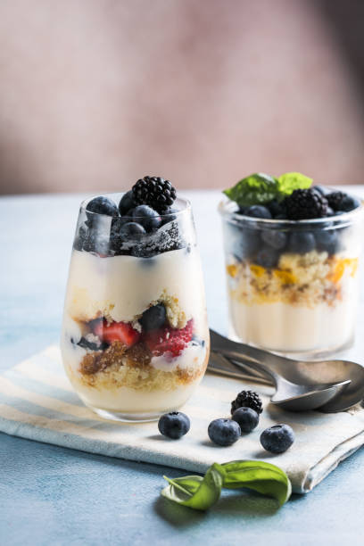 istock Trifle dessert with berries and cream on wooden table. Copy space 1812493272