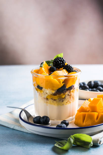 istock Trifle dessert with berries and cream on wooden table. Copy space 1812493290