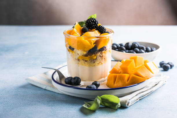 istock Trifle dessert with berries and cream on wooden table. Copy space 1812493291