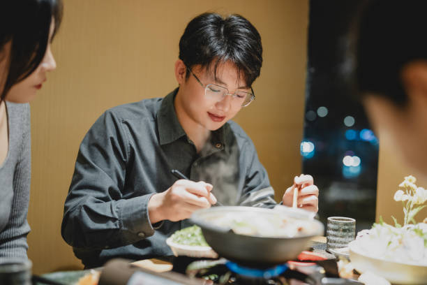 istock Young people eat at a Japanese restaurant 1812500720