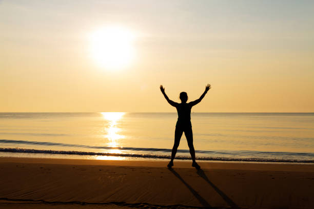 istock Woman exercise with sunrise at beach Bang Boet 1812509213