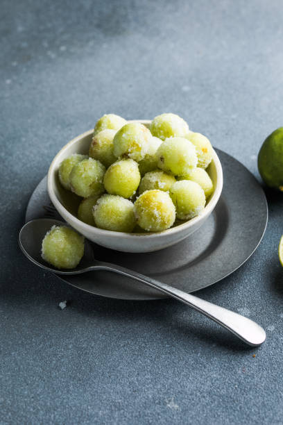 istock Sour candy grapes in a bowl and cooking ingredients on the table 1812520502