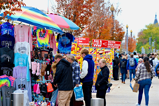 Washington, D.C., USA - November 20, 2023: Tourists look at merchandise at a souvenir stand outside the National Air and Space Museum on a cold autumn afternoon in the Nation’s Capital.