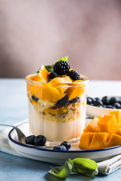 istock Trifle dessert with berries and cream on wooden table. Copy space 1812524719